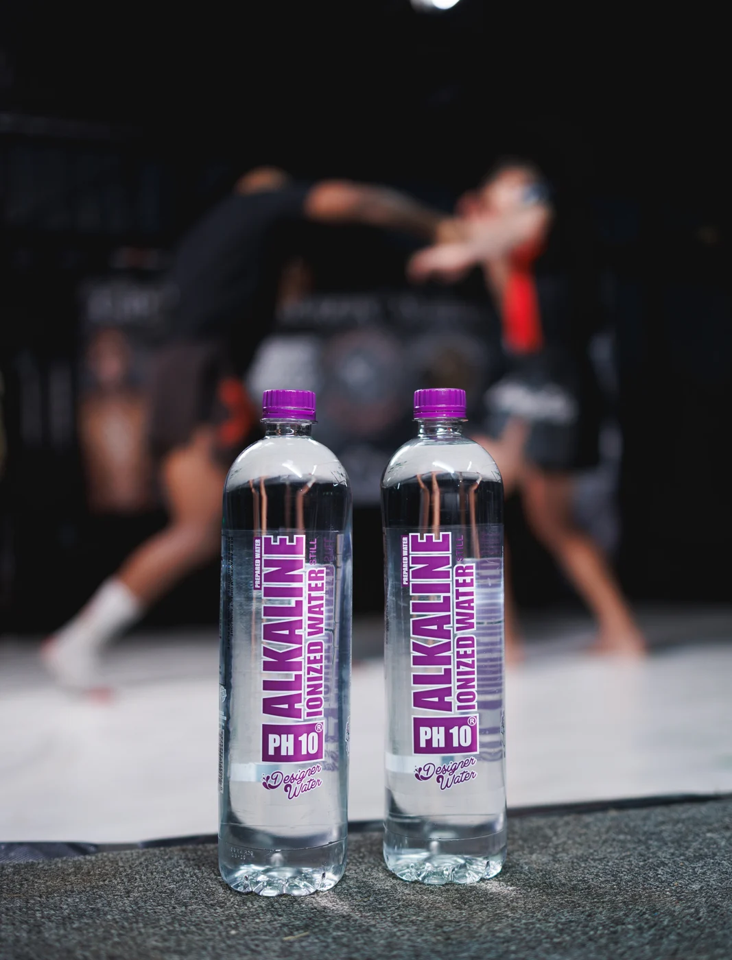 Designer Water pH10 bottles beside the PFL training cage