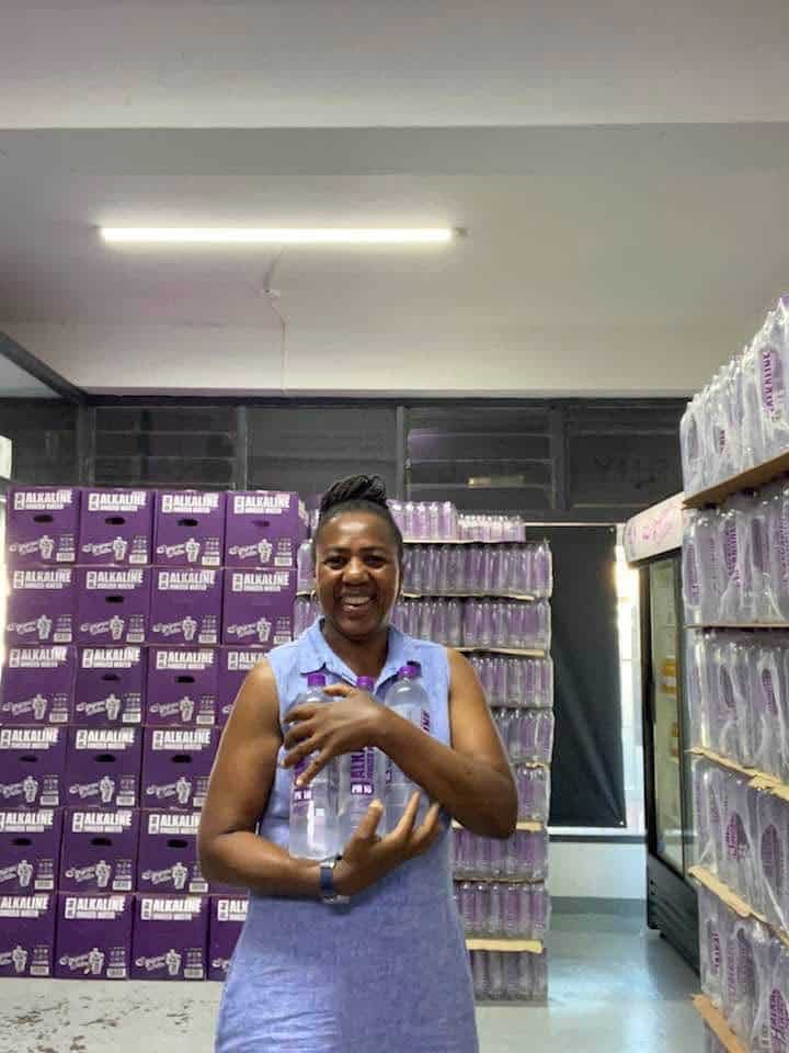 Gina holding Designer Water bottles in her shop, Durban North